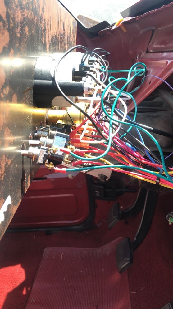 Back side of the custom dashboard showing wiring and switches